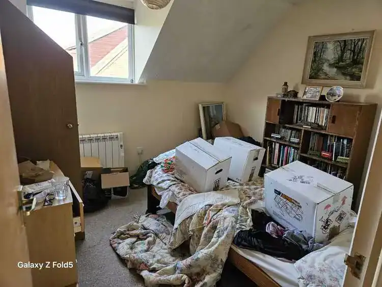 Cluttered room before clearance in Enfield, North London
