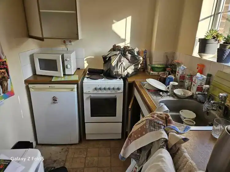 Cluttered room before clearance in Broxbourne, Hertfordshire