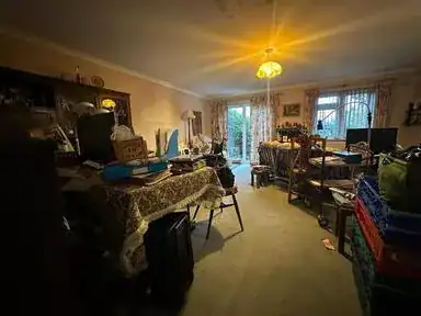Cluttered room before clearance in Welwyn Garden City, Hertfordshire