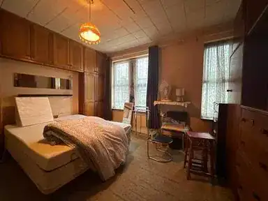 Cluttered room before clearance in Hatfield, Hertfordshire