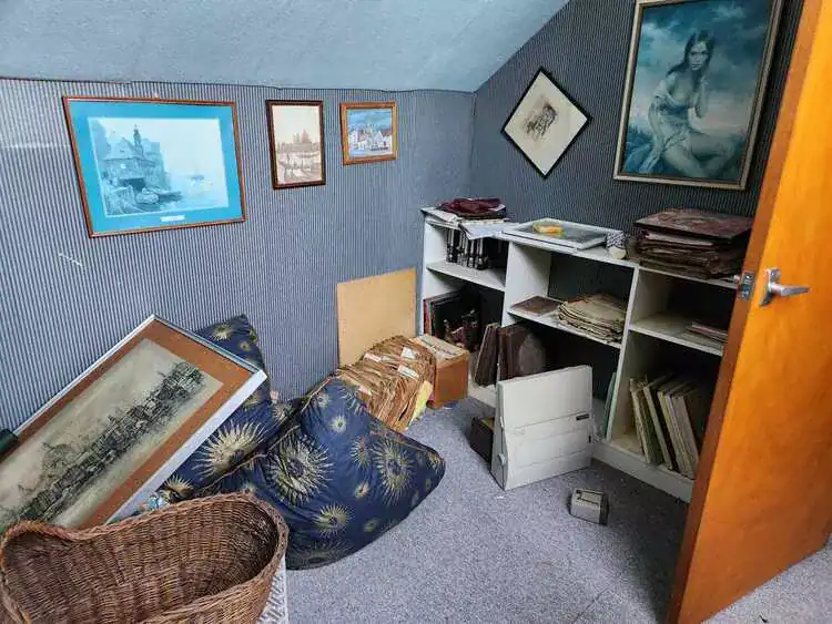 Cluttered room before clearance in Watford, Hertfordshire