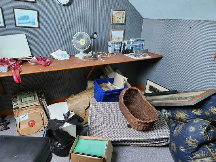Cluttered room before clearance in Camden, North London