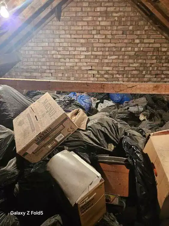 Cluttered room before clearance in Haringey, North London