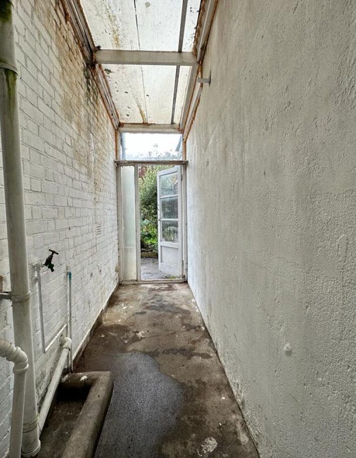 House clearance with a view of the side passageway to a house